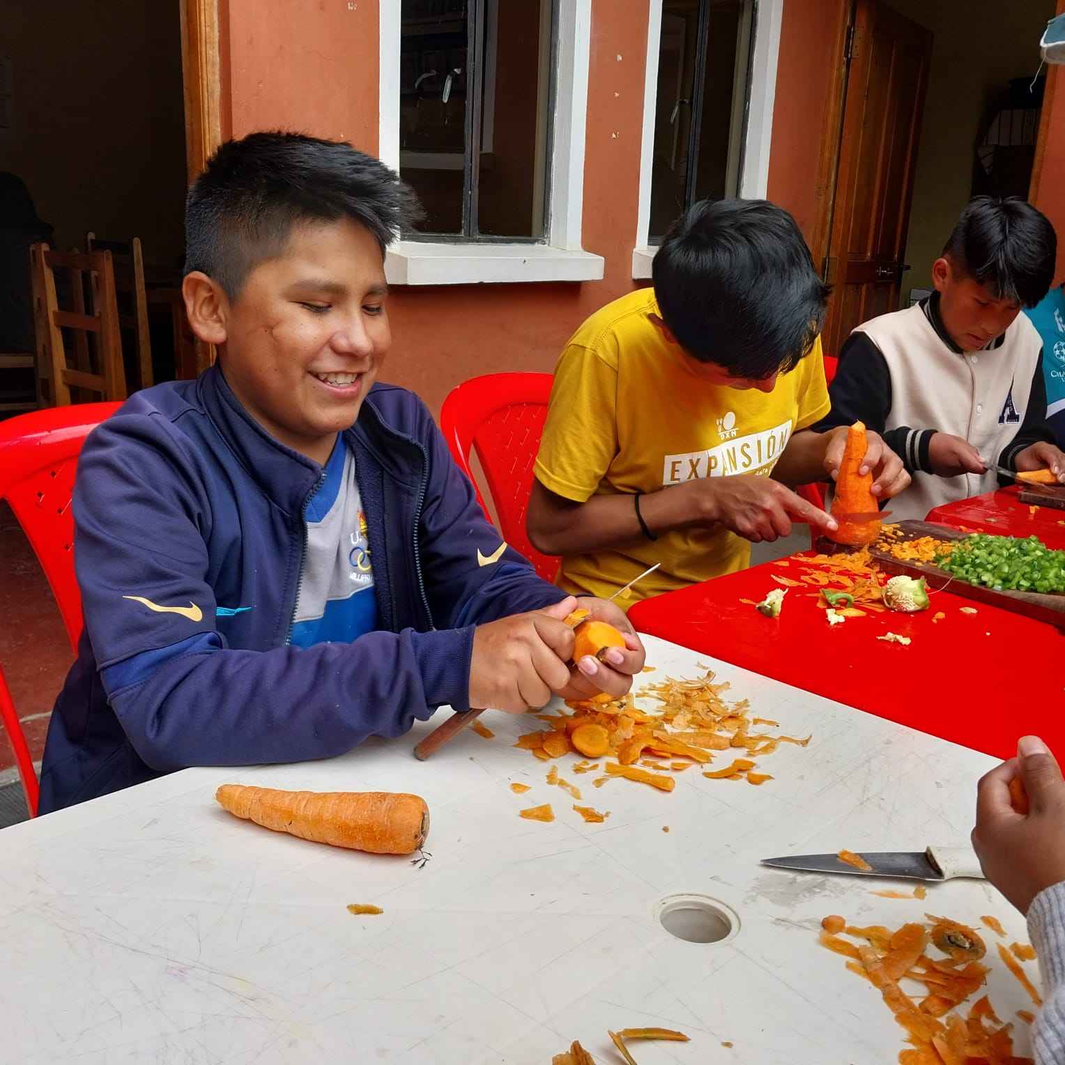 A group of people sitting at a table with food.