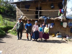 A group of people standing in front of a house.