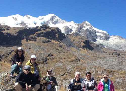 A group of people sitting on top of a rock.